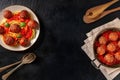 Meatballs banner design. Meatbalss with pasta, with tomato sauce and herbs, overhead flat lay shot on a dark background Royalty Free Stock Photo