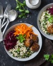 Meatballs, bulgur, carrots, beets bowl on dark background, top view Royalty Free Stock Photo