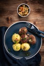 Meatballs with cheese served with boiled potatoes