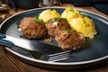 Meatballs with cheese served with boiled potatoes