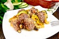 Meatballs with cheese and squash in plate on board