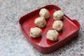 Meatballs are contained meat, flavoring and chopped vegetable which served on a red plate in Shabu or Sukiyaki restaurant