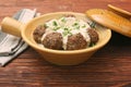 Meatballs with cream sauce in a ceramic pan