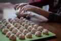 Meatballs on the cutting board. Cooking meatballs on a cutting board in the kitchen at home. Female hands on the background