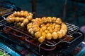 Meatballs are fried on an open-air stove at a street food market in Asia Royalty Free Stock Photo