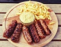 Meatballs meat french fries mutard plate sausages romanian mici Royalty Free Stock Photo