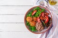 Meatballs, salad of tomatoes and buckwheat porridge on white wooden table. Healthy food. Diet meal. Buddha bowl. Royalty Free Stock Photo