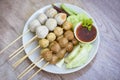 Meatballs on skewers on white plate and fresh vegetables cabbage yard long bean cucumber, Asian Thai food grilled meatballs Royalty Free Stock Photo