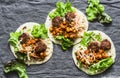 Meatballs, spicy stewed chickpeas and cabbage slaw tortilla - delicious snack, brunch, appetizers, tapas on a gray background