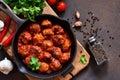 Meatballs in sweet and sour tomato sauce on the kitchen table. Top view