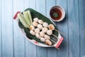 Pork ball skewers With cucumber on a plate on the wooden floor Royalty Free Stock Photo