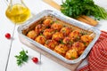 Meatballs in tomato sauce baked in an aluminum foil container. Diet meat dish