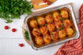 Meatballs in tomato sauce baked in an aluminum foil container. Diet meat dish. The top view