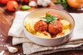 Meatballs in tomato sauce with ingredients in bakground. Royalty Free Stock Photo