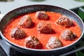 Meatballs in tomato sauce with ingredients in bakground. Royalty Free Stock Photo