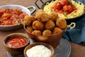 Meatballs in tomato sauce in metal pan on table with italian pasta Royalty Free Stock Photo