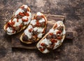 Meatballs, tomato sauce, mozzarella and arugula hot sandwiches on a rustic cutting board on a wooden table, top view. Delicious sn Royalty Free Stock Photo