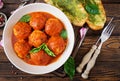 Meatballs in tomato sauce and toast with basil pesto. Dinner. Royalty Free Stock Photo