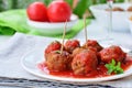 Meatballs in tomato sauce on white plate