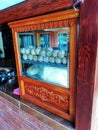 meatballs,white noodles and vegetables in a carved wooden display case,side view