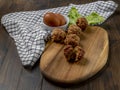 Meatballs on a wooden cutting board with two eggs and a salad leaf Royalty Free Stock Photo