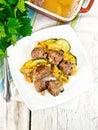 Meatballs with zucchini and nuts in plate on board top