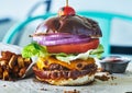 Meatless vegan cheese burger on pretzel bun Royalty Free Stock Photo