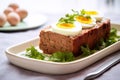 meatloaf with boiled eggs on top of a white marble countertop Royalty Free Stock Photo
