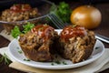 Meatloaf muffins made with a blend of ground beef and sausage, served with a side of sauteed mushrooms and onions