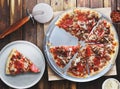 Meaty pepperoni and sausage pizza sliced on metal tray Royalty Free Stock Photo