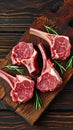 Meaty vision Raw lamb cutlets on bone, dark wooden background