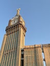 Blue sky with Abraj Al Bait (Royal Clock Tower Makkah) hotel with big clock on top, in Mecca, Saudi Arabia.