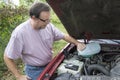 Mechanic Adding Winshield Wiper Fluid To Vehicle.