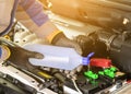 The mechanic adds distilled water check the car battery Royalty Free Stock Photo