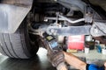 Mechanic adjusting the chamber area during wheel alignment process