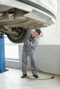 Mechanic Adjusting Tire, Smiling