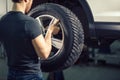 Mechanic adjusting tire wheel at repair garage Royalty Free Stock Photo