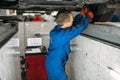 Mechanic adjusts the wheel angles on stand