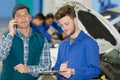 mechanic apprentice holding clipboard