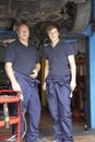 Mechanic and apprentice working on car Royalty Free Stock Photo