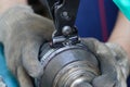 mechanic assembles a rubber cover for a car axle in a service center.Cv Clamp Tool And Cv Joint Boot Clamp Pliers Set