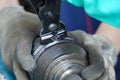 mechanic assembles a rubber cover for a car axle in a service center.Cv Clamp Tool And Cv Joint Boot Clamp Pliers Set