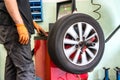 Mechanic balancing a car wheel