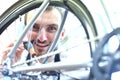 Mechanic in a bicycle repair shop oiling the chain of a bike