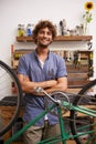 Mechanic, bicycle and smile with tools at workshop for repair, maintenance with small business. Entrepreneur, handyman Royalty Free Stock Photo