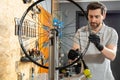 Mechanic in black gloves inspecting wheel Royalty Free Stock Photo