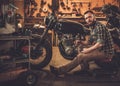 Mechanic building vintage style cafe-racer motorcycle