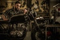 Mechanic building vintage style cafe-racer motorcycle