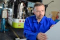 Mechanic in bus depot Royalty Free Stock Photo