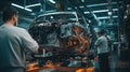 A mechanic in a car factory is installing engines for cars on the production line inside the factory